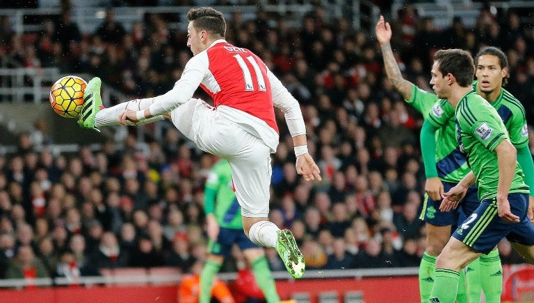 Mesul Özil baja el balón con el Arsenal