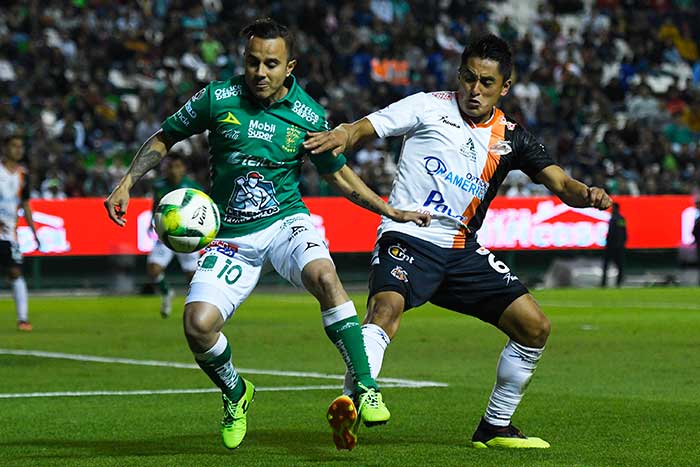 Luis Montes y Michael García pelean un balón