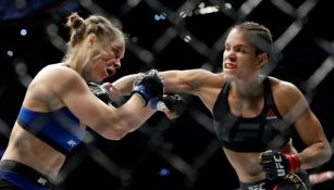 Amanda Nunes soltando golpes a Ronda Rousey durante UFC 207