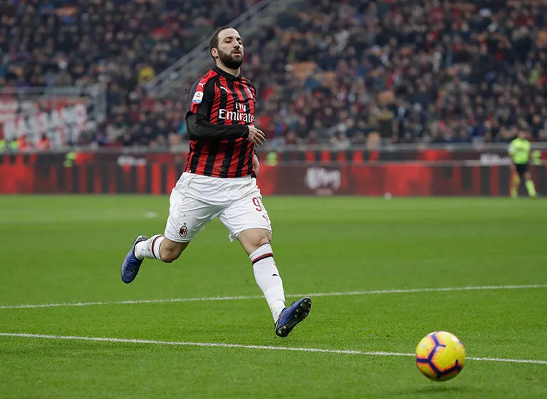 AP Higuaín persigue un balón en un partido con el Milan