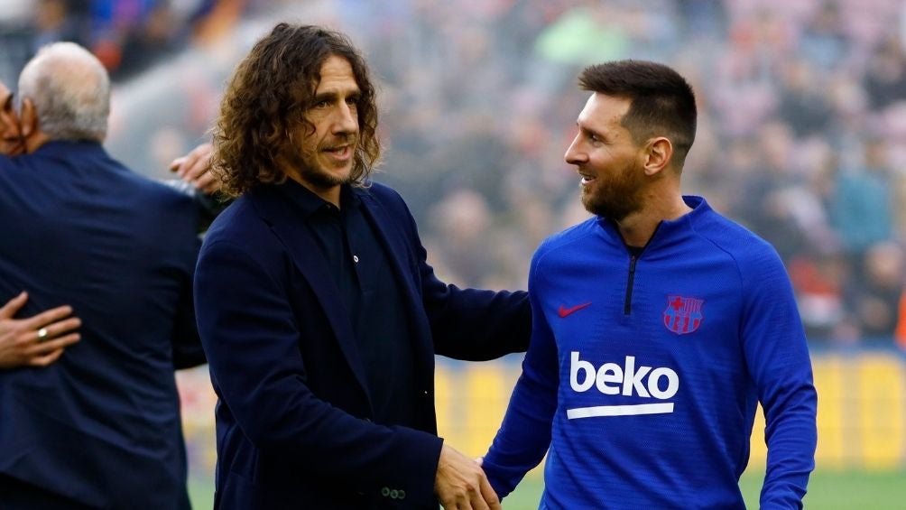 Carles Puyol junto a Lionel Messi 