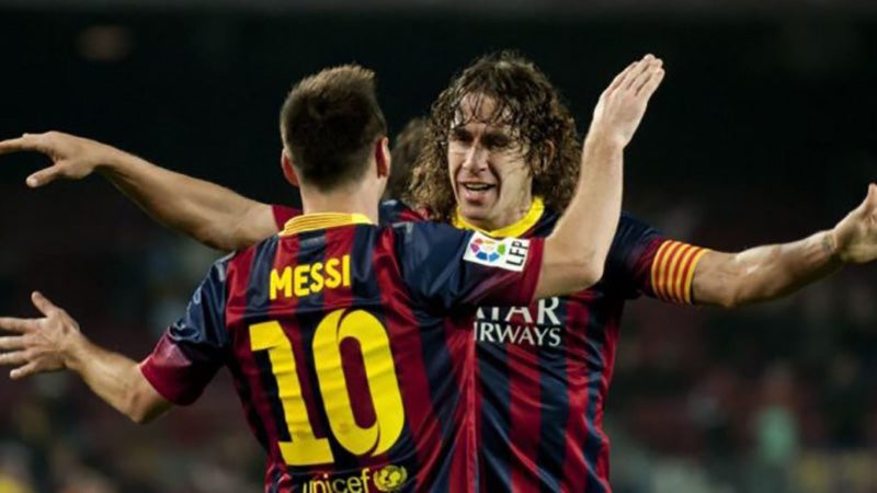 Carles Puyol y Lionel Messi durante un duelo en Barcelona 