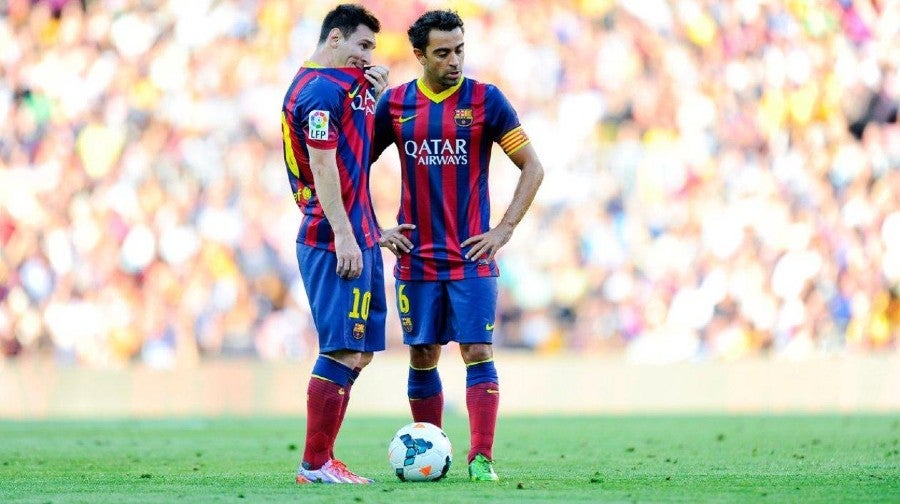 Messi y Xavi durante un partido con Barcelona