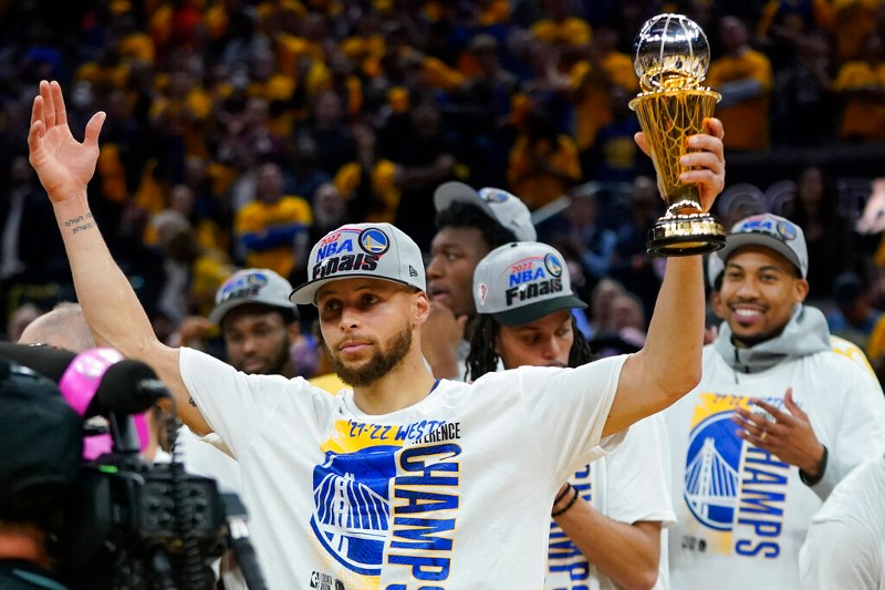 Stephen Curry holds the MVP trophy