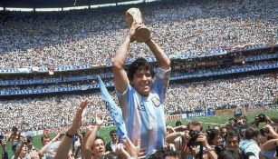 Maradona es levantado en hombros en la cancha del Azteca mientras levanta la Copa del Mundo