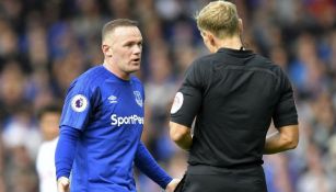 Wayne Rooney discute con el árbitro durante un partido 