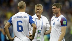 Heimir Hallgrímsson habla con dos seleccionados de Islandia