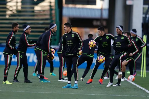 Héctor Moreno al frente sonríe mientras sus compañeros entrenan