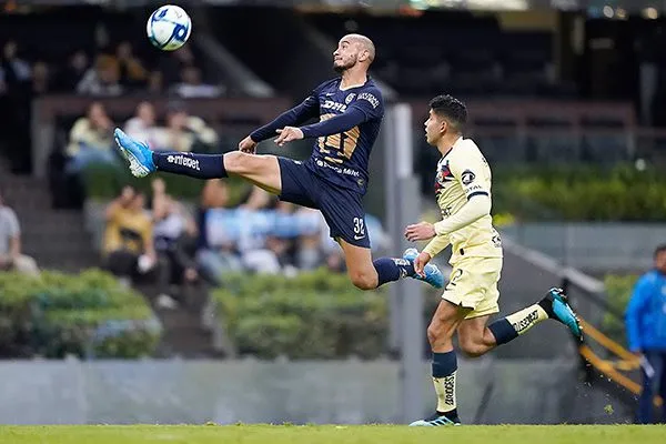 Carlos González en disputa por el balón