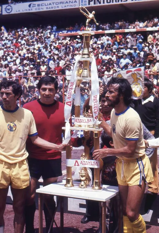 Jugadores del plantel 75-76 levantan la copa