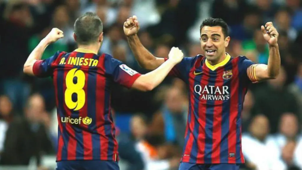 Xavi e Iniesta en festejo