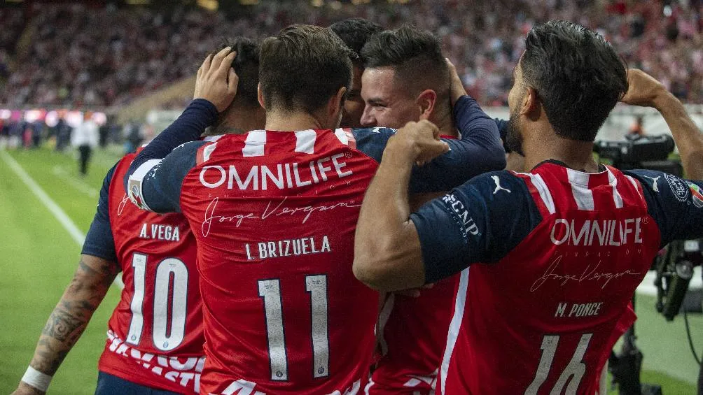Jugadores de Chivas celebrando gol en partido de la Liga MX
