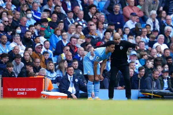 Pep Guardiola junto a jugador del City