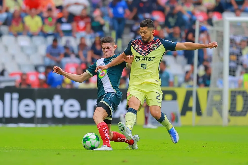 Israel Reyes disputa el balón con Henry Matín