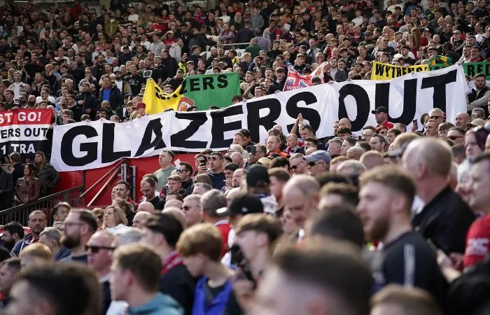 Afición del Manchester United con letrero GLAZERS OUT
