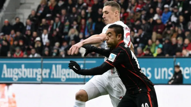 Marco Fabián pelea un balón frente al Augsburgo