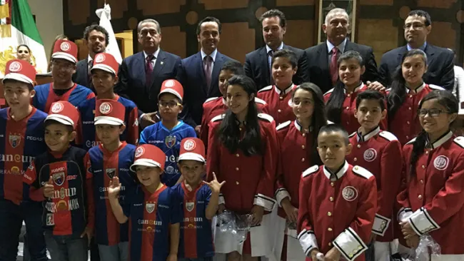 Niños de Fuerzas Básicas de Atlante se toman la foto con los 'gritones' de la Lotería Nacional