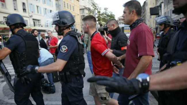 Policías deteniendo a Hooligans 