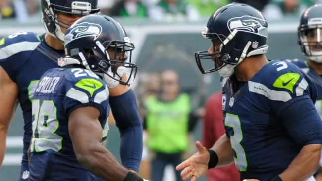 Wilson y CJ Spiller celebran un TD