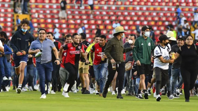 Aficionados buscando refugio en la cancha de la Corregidora