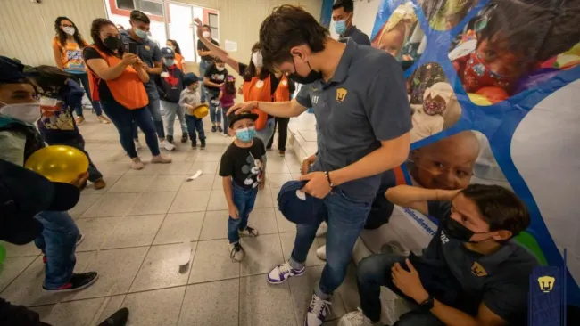 Jugadores de Pumas con los niños