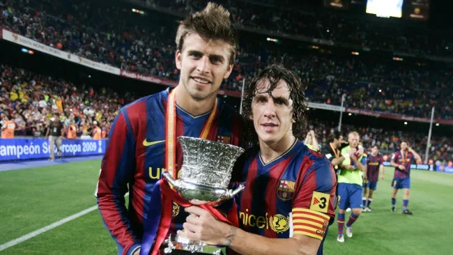 Piqué y Puyol celebrando un título del Barcelona