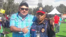 Hombre que perdió cartera en el GP de México posa junto al policía que le regreso su billetera