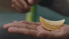 Una mano con unas papas Pringles
