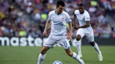 Lozano durante partido contra Barcelona en Champions
