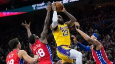 Jugadores de Philadelphia 76ers tratan de detener a LeBron James