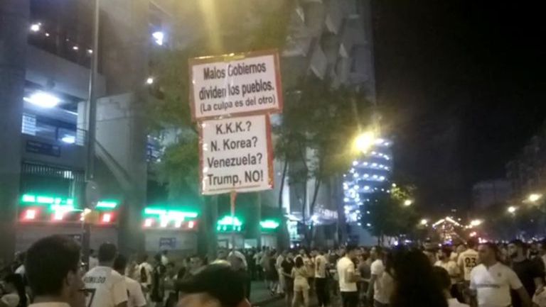 Aficionados enseña pancarta contra Trump