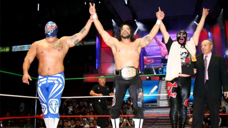 Terrible (centro) festeja su triunfo en la Arena México