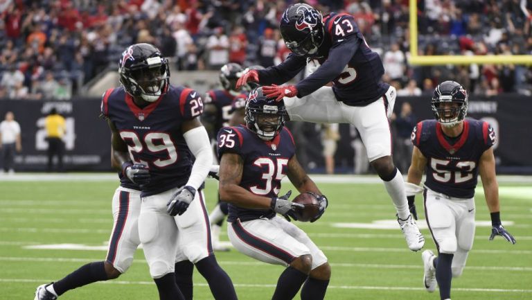 Eddie Pleasant celebra con sus compañeros después de hacer una intercepción contra los Cardinals