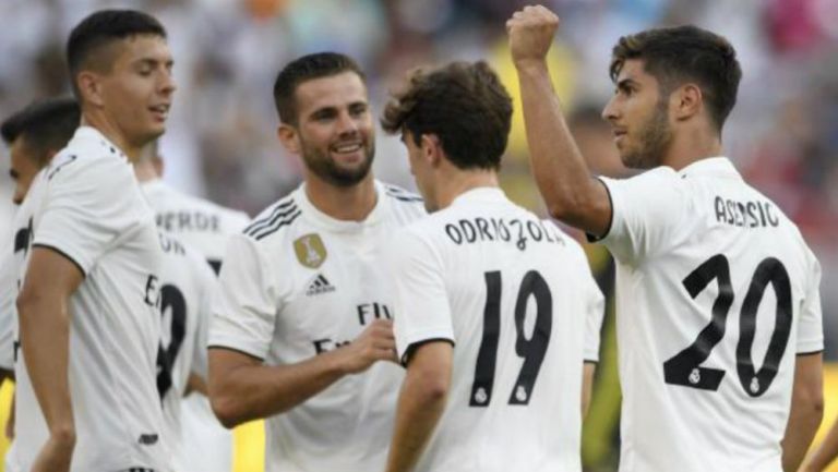 Odriozola y Asensio celebran un gol con el Madrid