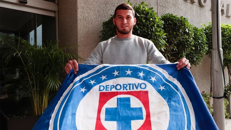 Juan Escobar posa con una bandera de Cruz Azul