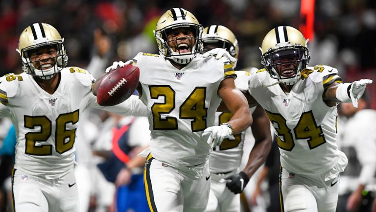 Jugadores de Saints celebran una jugada defensiva